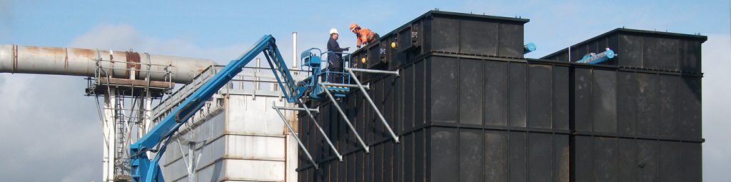 Two men on top of a new filter system